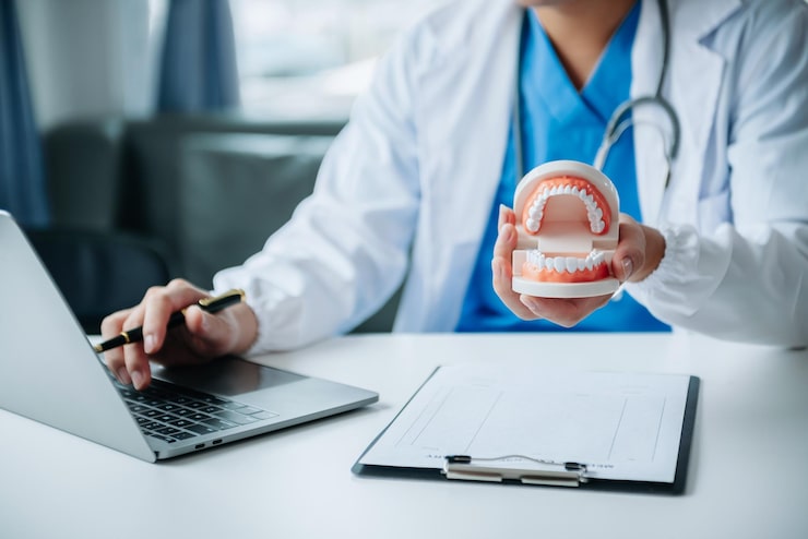 A clinician at a practice desk reviewing patient notes